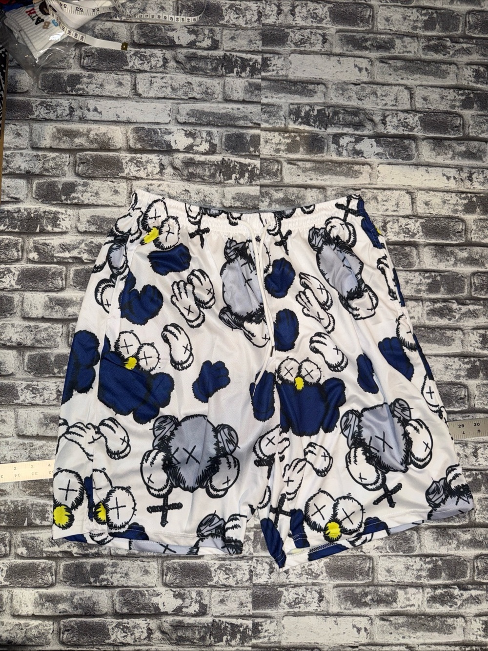 Kaws print shorts feature a blue And Grey Kaws pattern - Sz L - NWOT